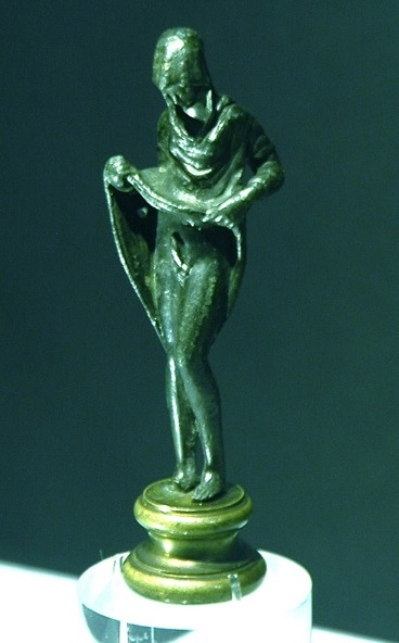 statue of a woman raising her dress to reveal an erect penis